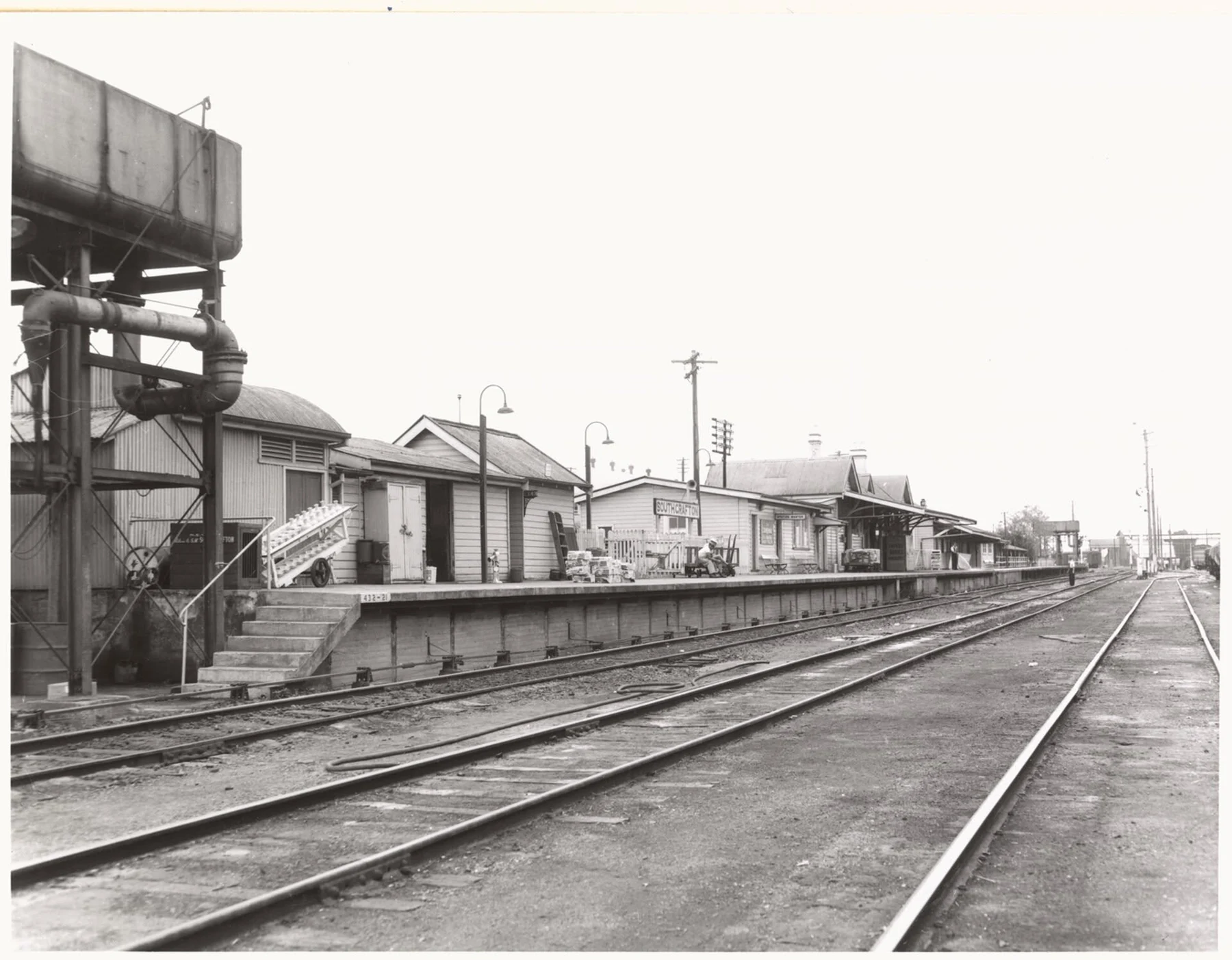 Historic black and white photograph looking along the South Grafton Station platform, buildings and yard tracks.